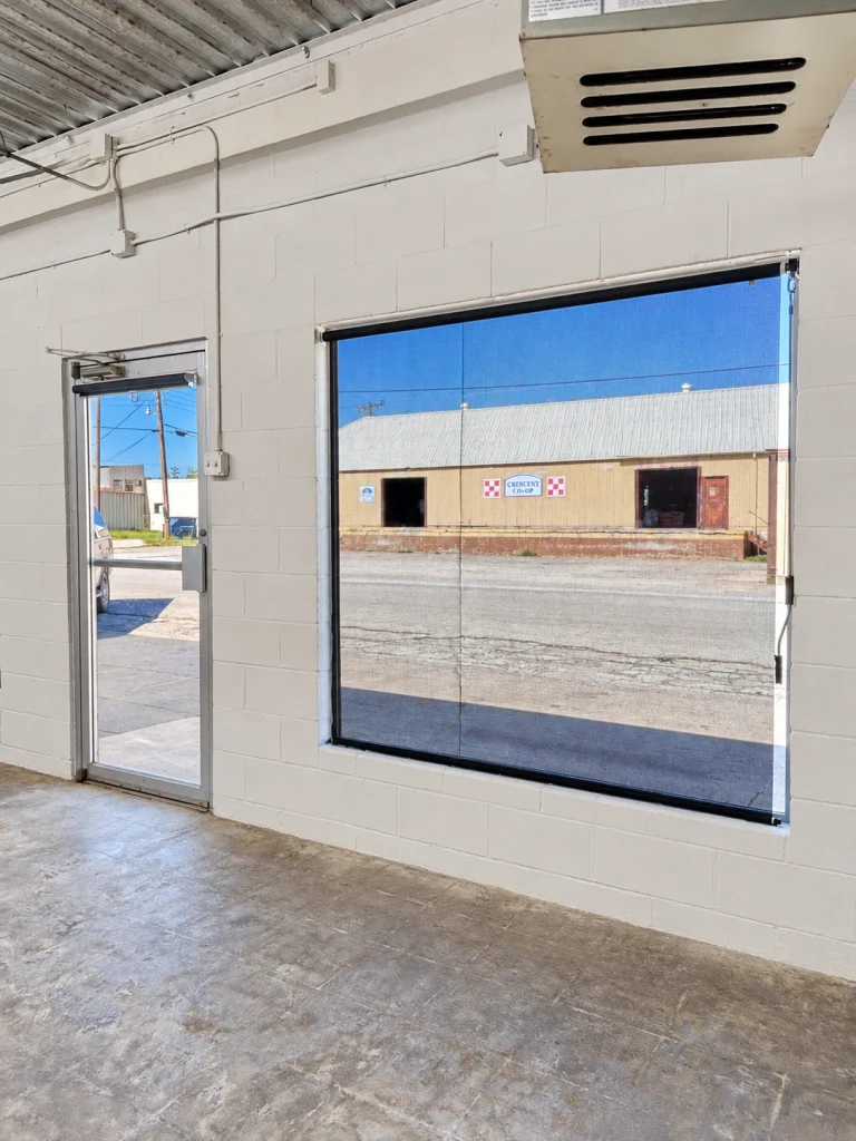 Home Interior view of the front glass entry door and large storefront window overlooking Madison Street.