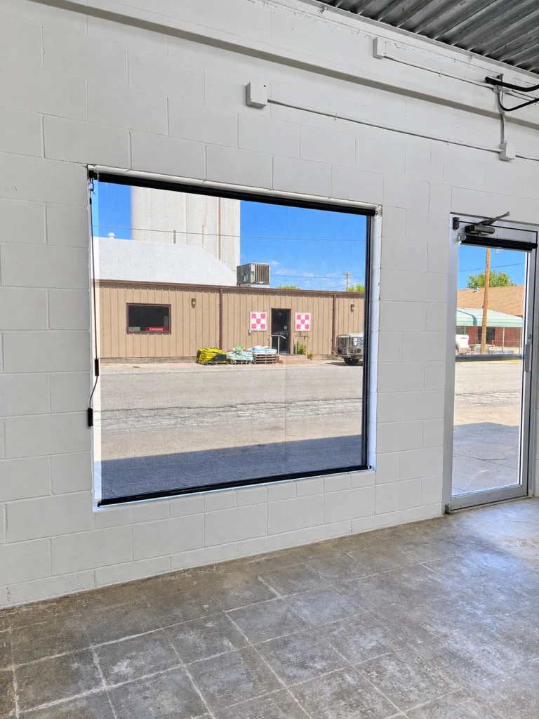 Home Interior view of large storefront windows and glass entry door facing Madison Street.